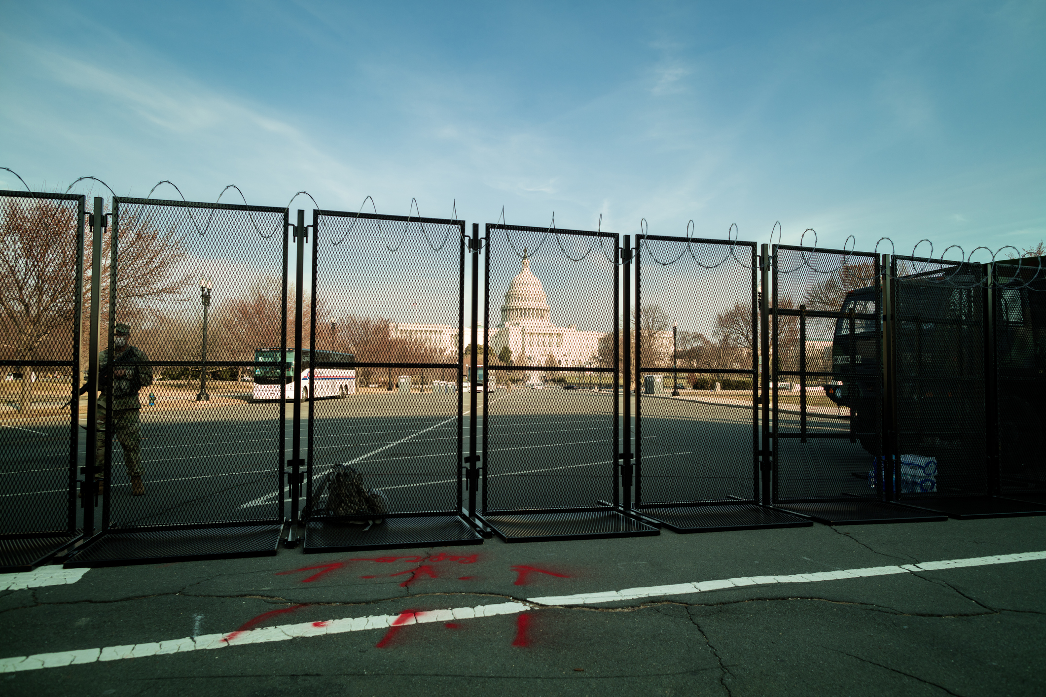 Soldier Standing Guard Behind Security Fence at U.S. Capitol Building after January 6th Insurrection stock photo