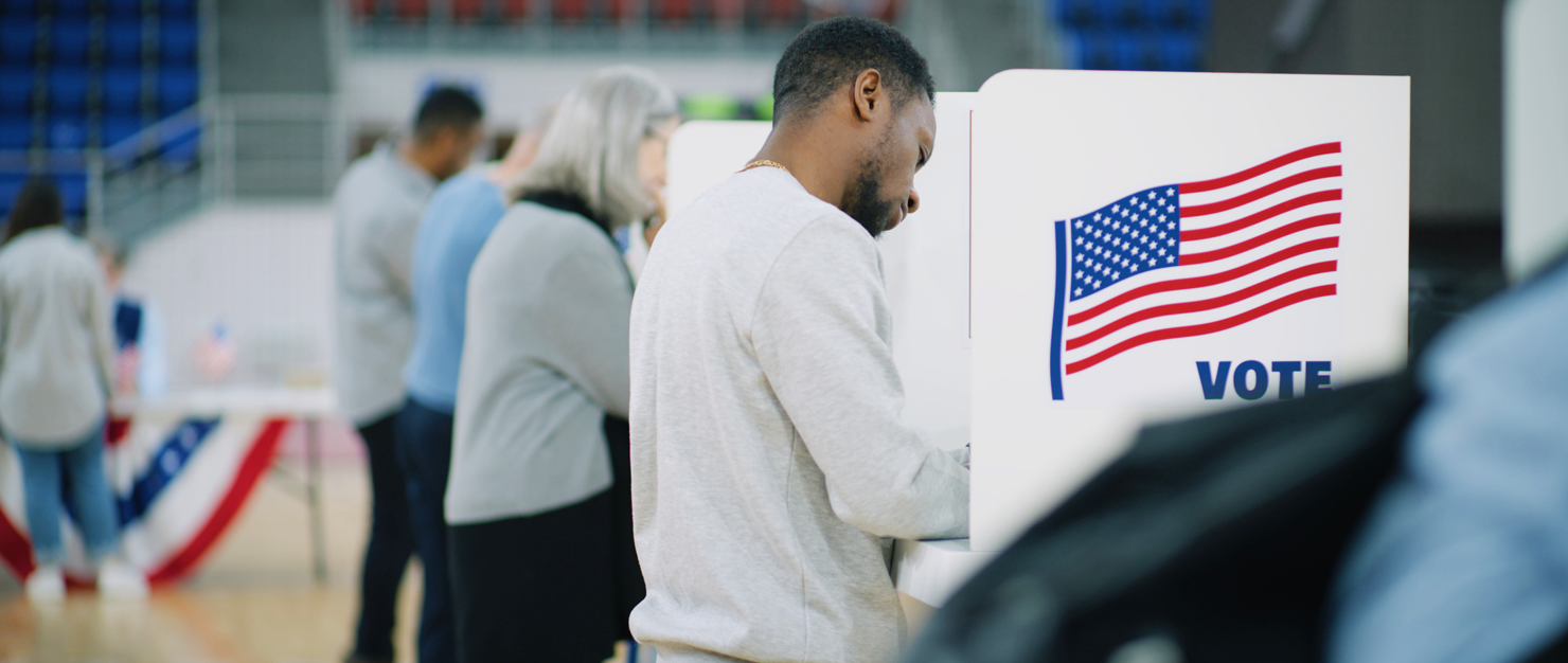 three people at individual voting stations