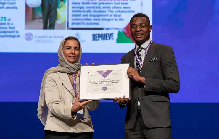 A rep from the Malawi Resentencing Project accepts one of five 2019 World Justice Challenge awards.